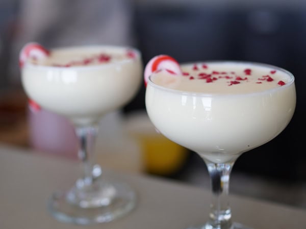 two glasses of Christmas-inspired cocktail at Aviary Rooftop Bar