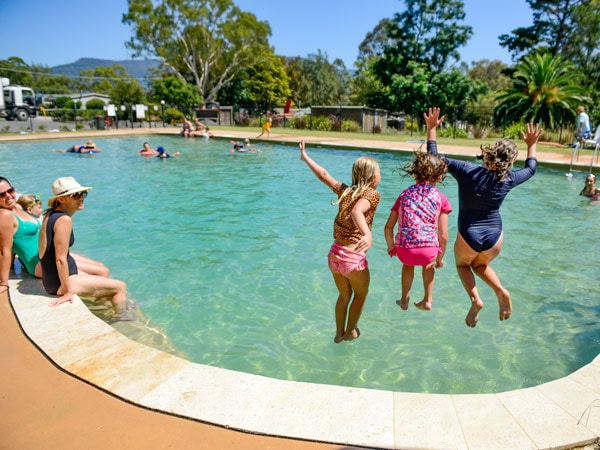 kids jumping into the swimming pool at Glenmack Park, Kangaroo Valley