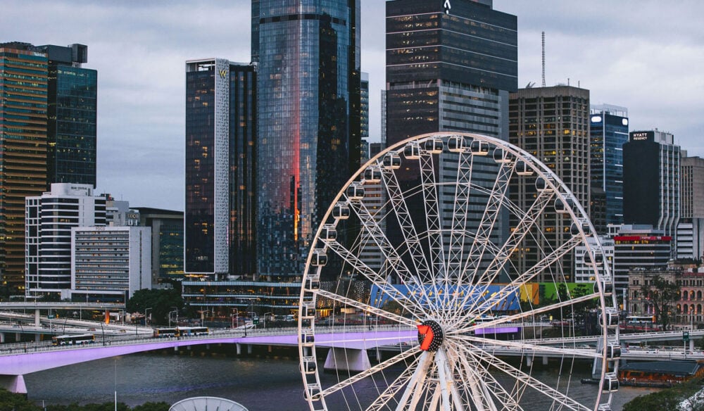 the top view of the Wheel of Brisbane with tall buildings in the background