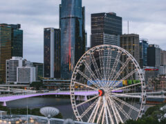 the top view of the Wheel of Brisbane with tall buildings in the background