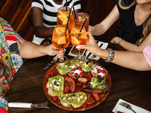 friends clinking their cocktail glasses at Brewtide Brewery, Brisbane