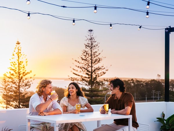 friends enjoying drinks at sundown, Straddie Brewing Co.
