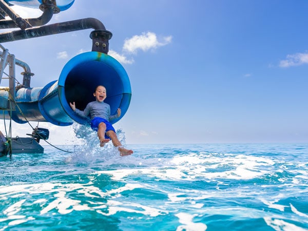 Kid on a waterslide onboard Sunlover Reef Cruise, Cairns