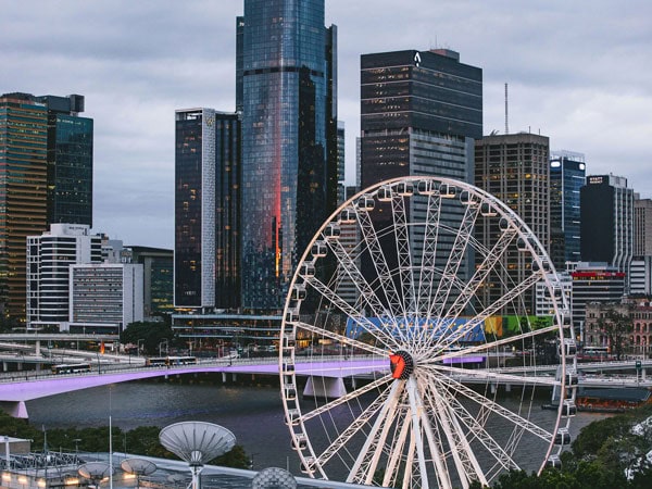 a top view of the Wheel of Brisbane with tall buildings in the background