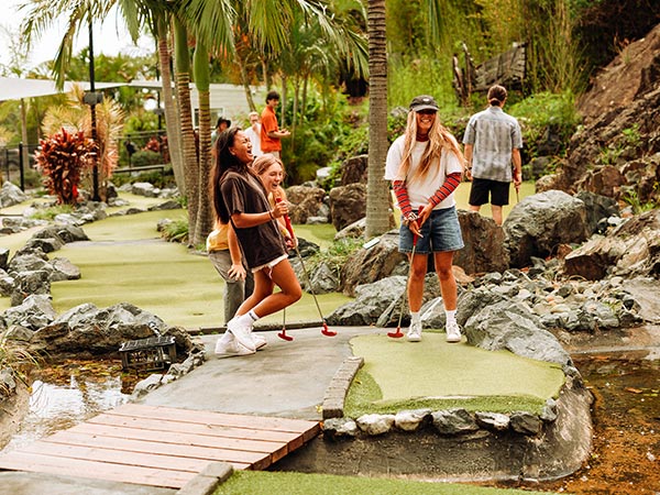 teenagers playing mini golf at the big banana fun park