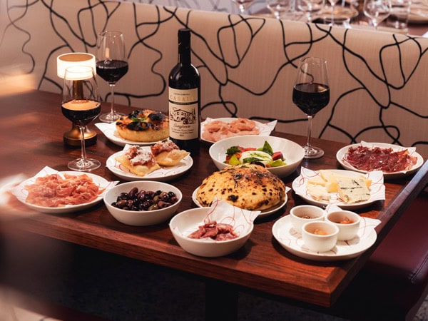 Italian dinner on the table at Bar Infinita