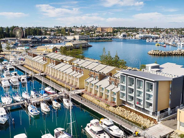 an aerial view of vessels docked in the fishing harbour next to Be Fremantle apartments