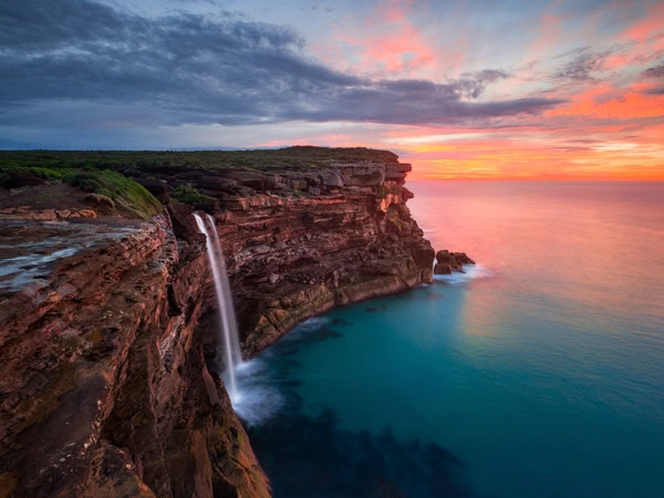 a scenic view of Curracurrong Falls at sunset
