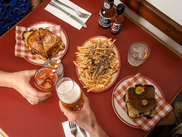 a spread of food and drinks on the table at Dirty Doris