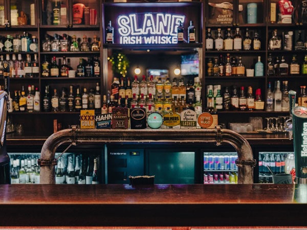 the tap beer counter with a selection of spirits on display at Finn McCool's