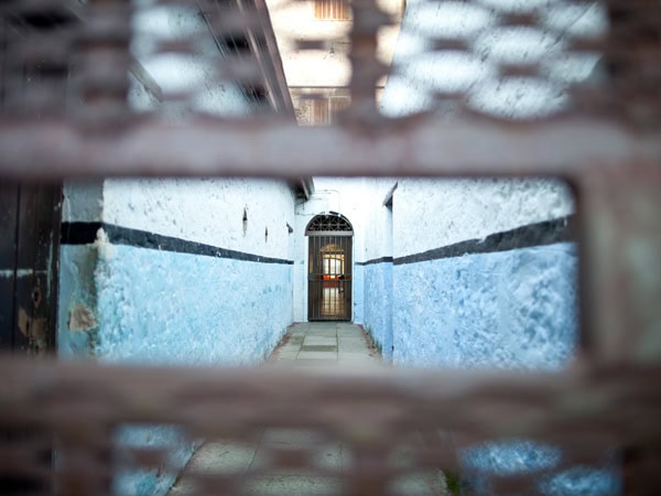 peeking through a small hole in the corridor of Fremantle Prison