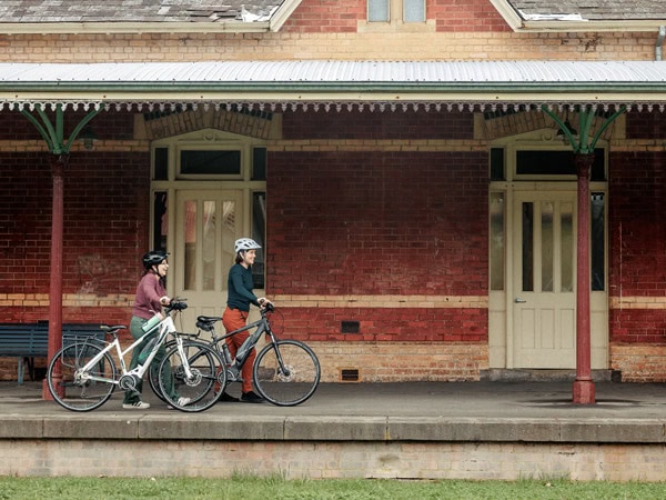 two bikers exploring a historic structure along the Great Victorian Rail Trail