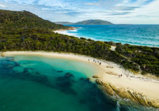 an aerial view of sapphire seas and lush greenery on Flinders Island