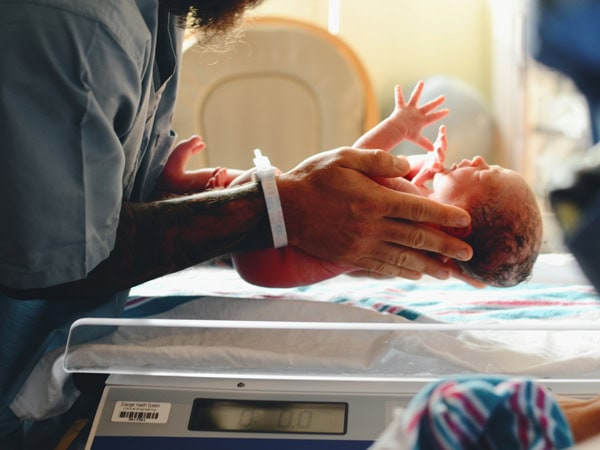 holding a newborn baby