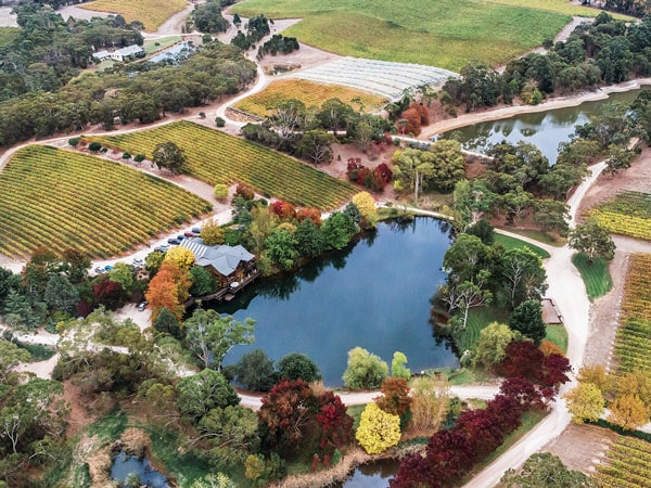 an aerial view of K1 By Geoff Hardy winery estate surrounded by a lake