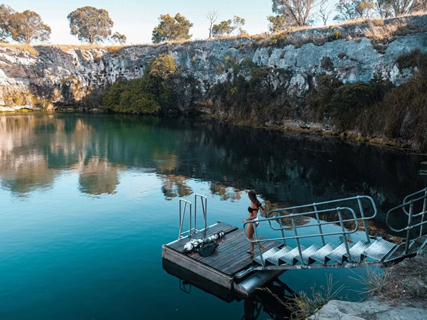 a woman standing on the swimming platform at Little Blue Lake