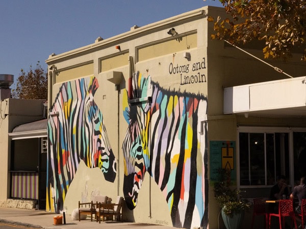 the facade of Ootong & Lincoln with colourful giraffe painting