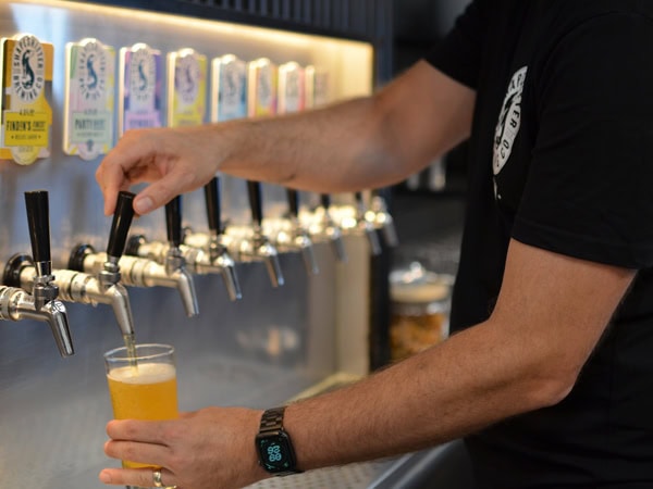 pouring a tap beer into a glass at Shapeshifter