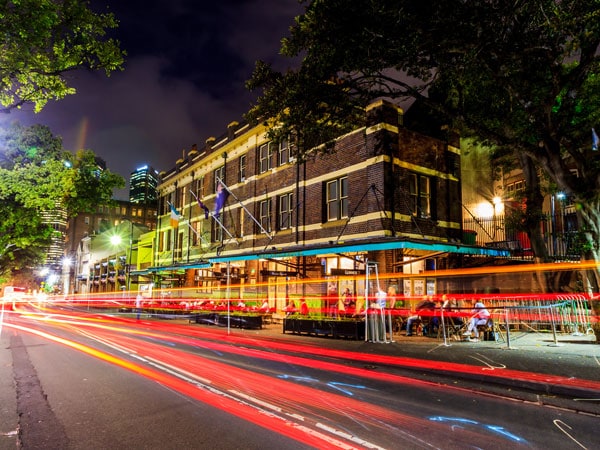 the pub exterior of The Mercantile with colourful glowing lines moving fast in the background