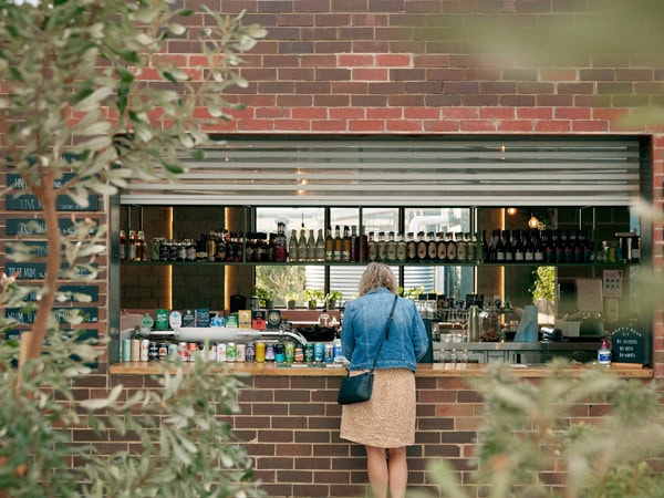 a woman ordering a drink at Urban Ground