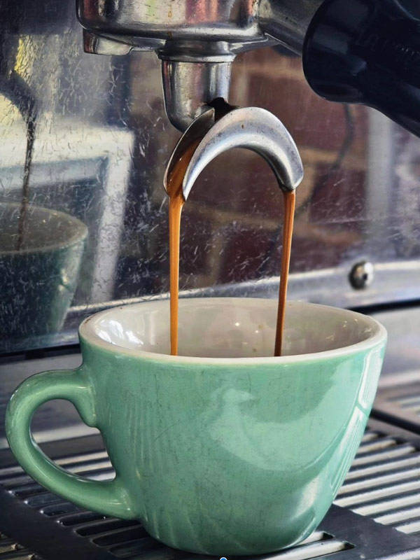coffee pouring into a cup from an espresso machine at Phat Milk, best cafes in Melbourne