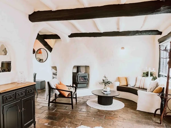 a rustic living room interior with a fireplace at 1800’s city cottage, Adelaide