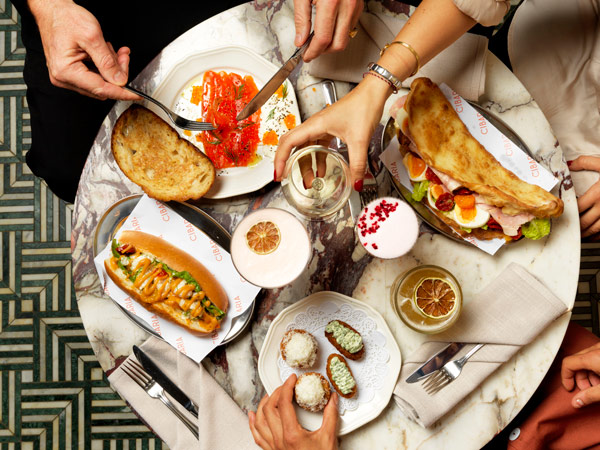 a table-top view of food and cocktails at 55 North by Cibaria