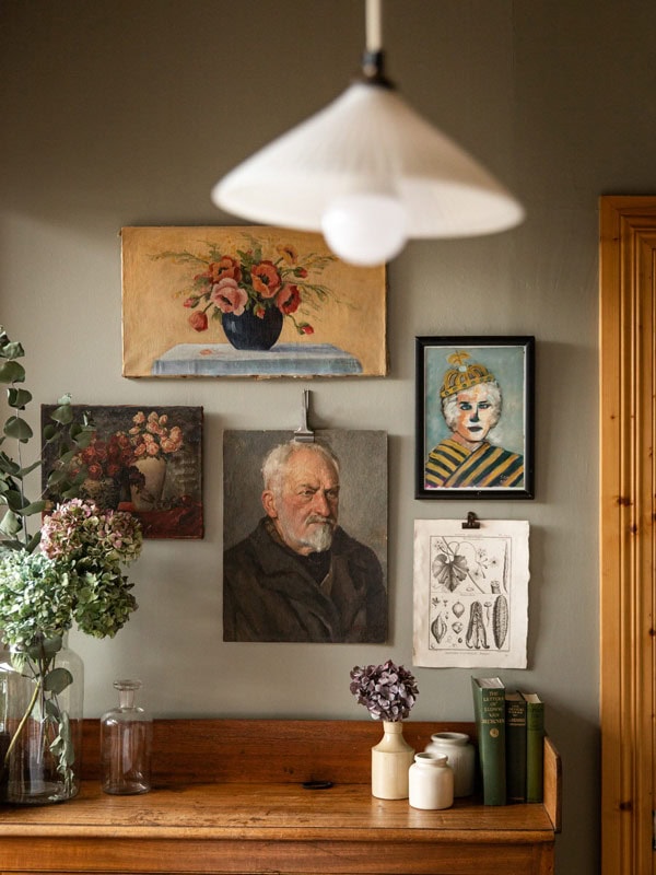 portraits and paintings on the wall at Captains Cottage, Hobart