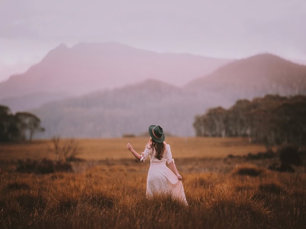 a woman admiring Mt Olympus from Derwent Bridge