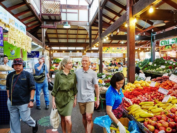 a couple browsing through the fruit stalls at one of the Fremantle markets