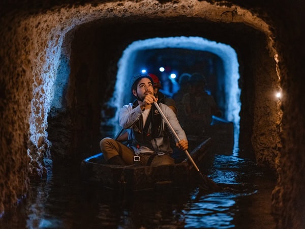 a man on a boat tour under a tunnel at Fremantle Prison