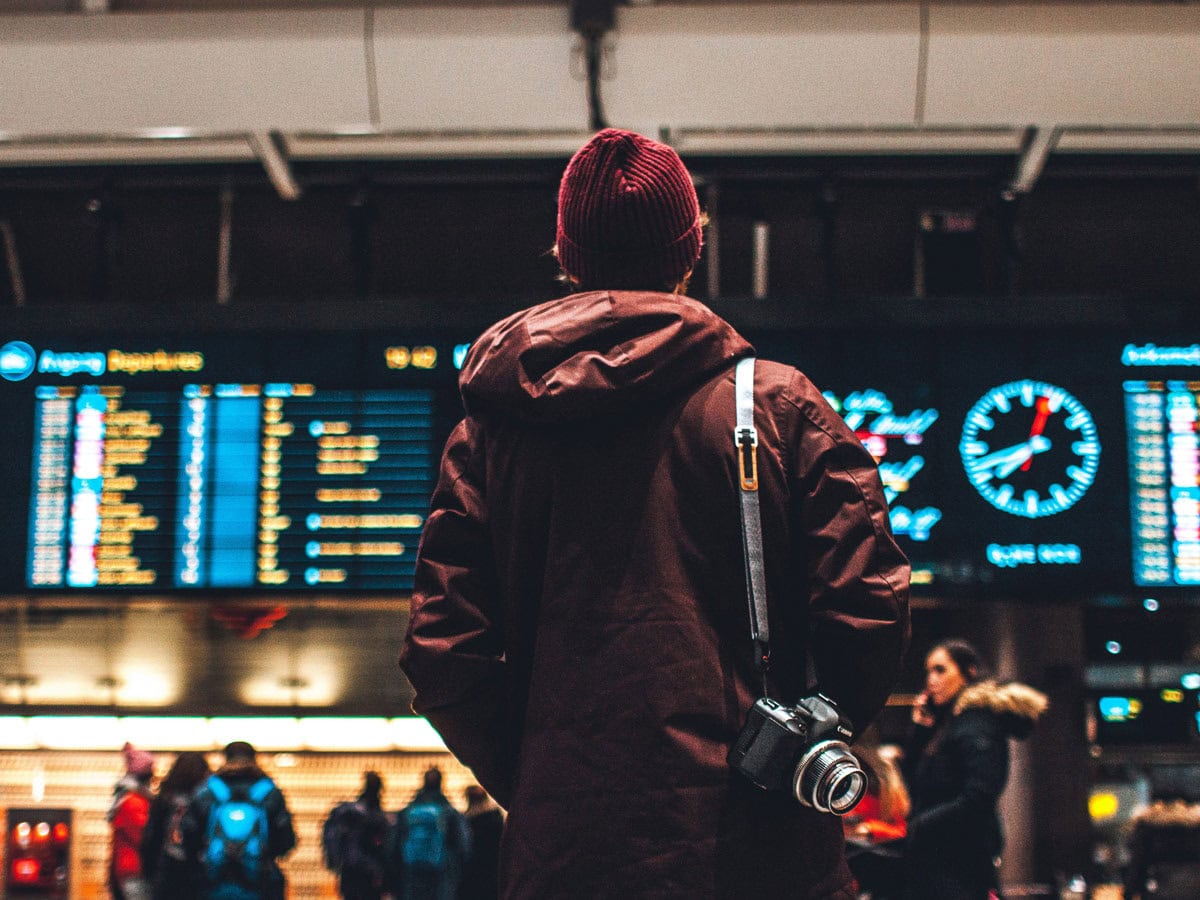 Person looking at flight schedule in airport