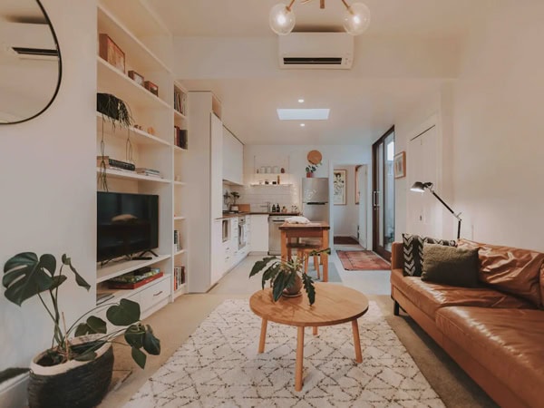 a look inside the whitewashed living room interior of Pickers Cottage, Hobart