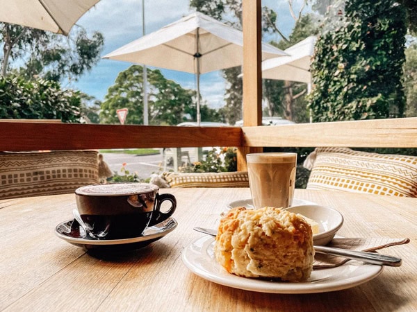 pastry and coffee on the table at Riverbank Café, Lorne