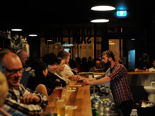 a bartender tending to customers at Saint John Craft Beer, Launceston