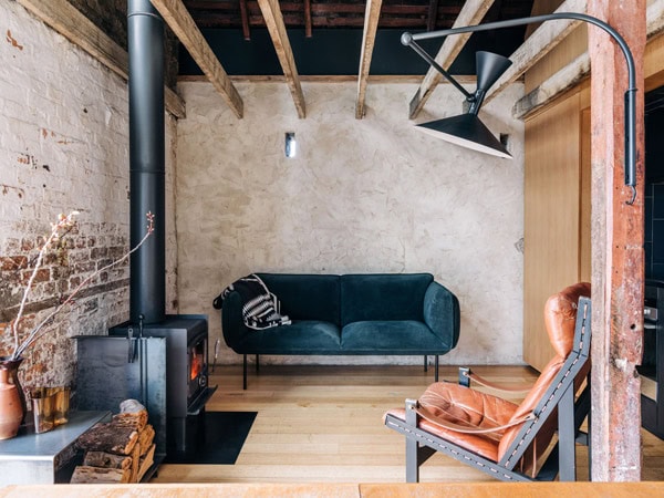 a rustic interior with a fireplace at The Barn