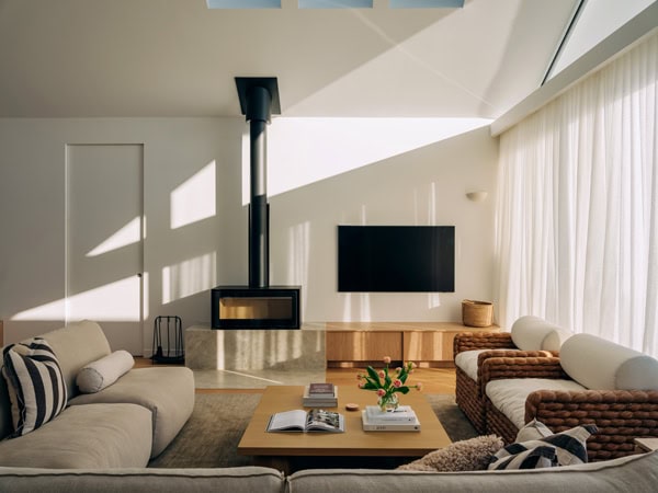 the living room interior with a fireplace at The Bay House