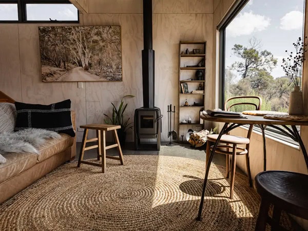 a bedroom with fireplace and huge window at Tiny George