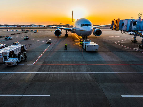 Plane on tarmac at sunset