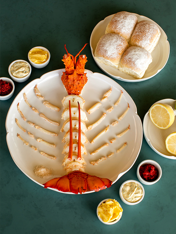 A lobster and some bread rolls.