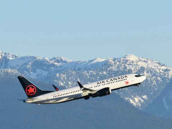 Air Canada plane flying over mountains