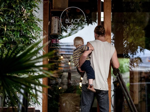 a man carrying his child to Black Vice Cafe and Roastery, Yarra Valley