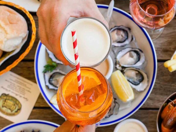 a top view of cocktail glasses above a plate of oysters in the Breakfast Creek Hotel