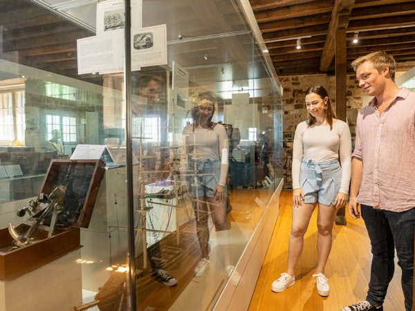 a couple browsing through the displays at Commissariat Store Museum