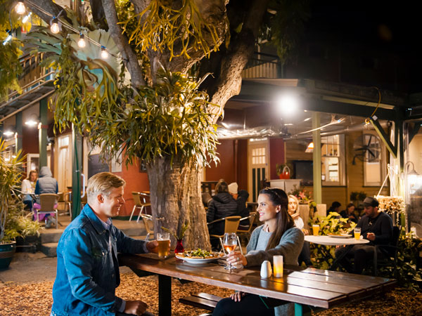 a couple enjoying food and drinks at the Eltham Hotel, Eltham