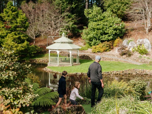 Grandpa with kids at Emu Valley Rhododendron Garden in Tasmania