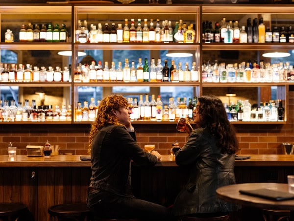 two people sitting at a bar in Frogs Hollow Saloon