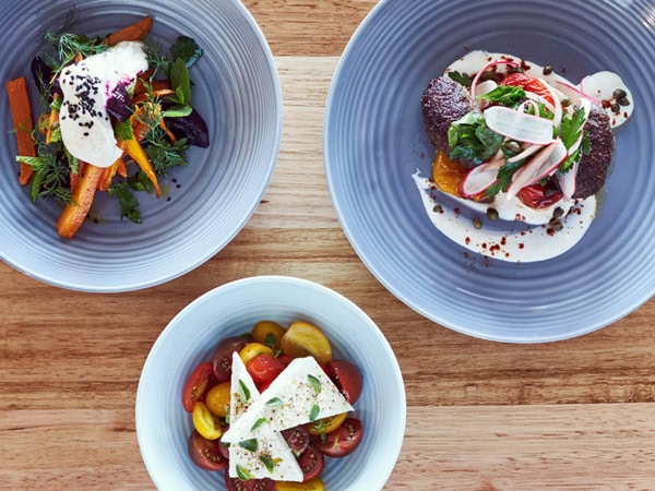 three plates of food on the table at IPSOS restaurant, Lorne