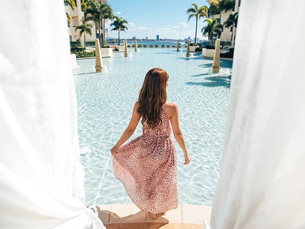 imperial hotel gold coast woman standing in front of pool