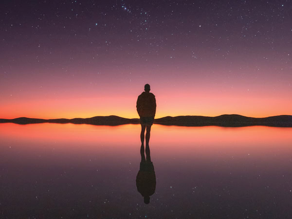 a person silhouetted against the sunset landscape at Lake Gairdner, SA